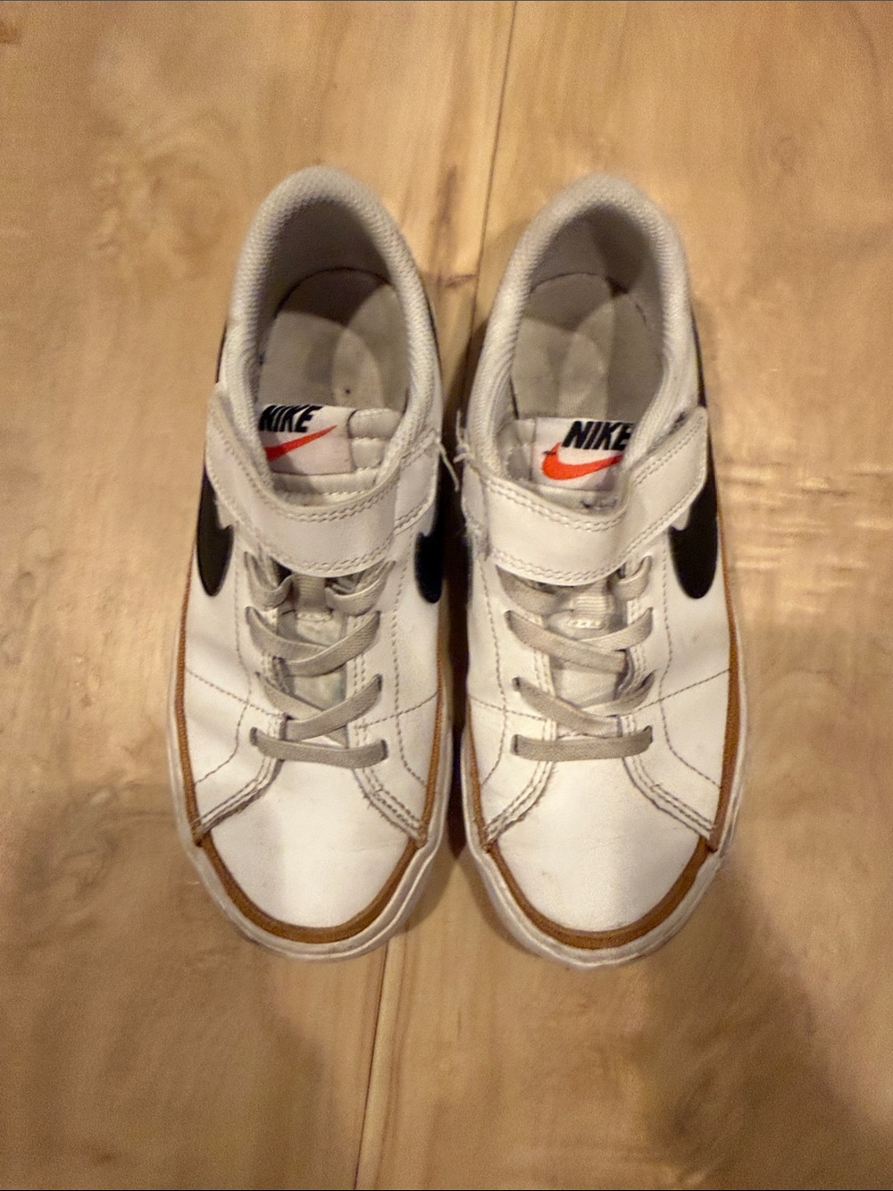 Nike Kids White Sneakers with Black Swoosh and Orange Accent